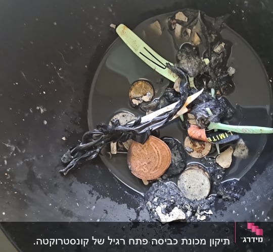 חפצים שונים בפח, כולל מזלג פלסטיק וחפצים שרופים
